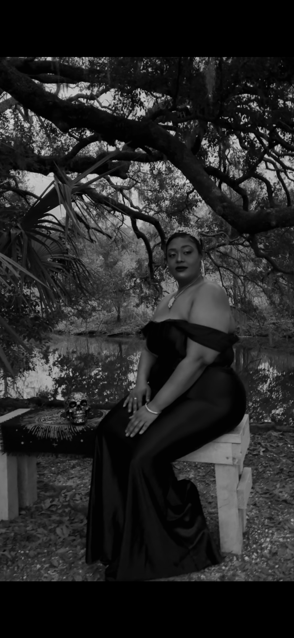 Black-and-white editorial photograph of J. Woods beneath Louisiana trees
